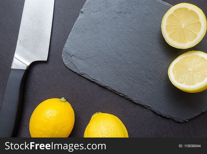 Photography of Sliced Lemon Near Kitchen Knife