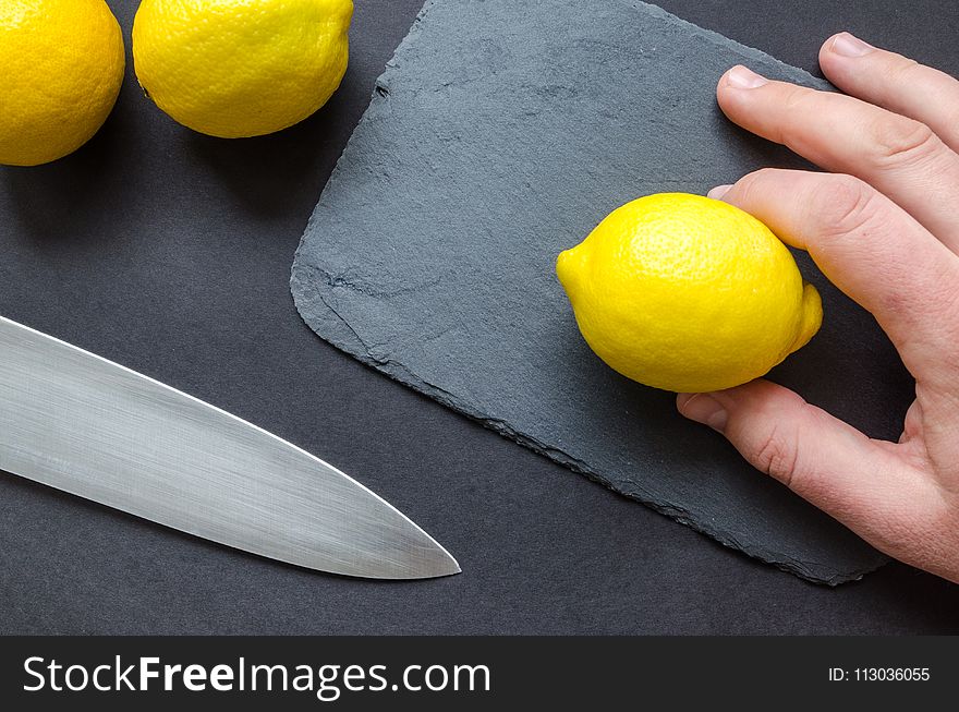 Person Holding A Lemon