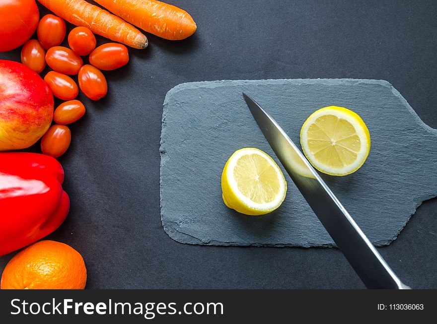 Sliced Lemon On Gray Chopping Board