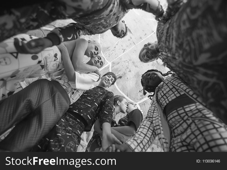 Grayscale Photo Of People Together Inside Room