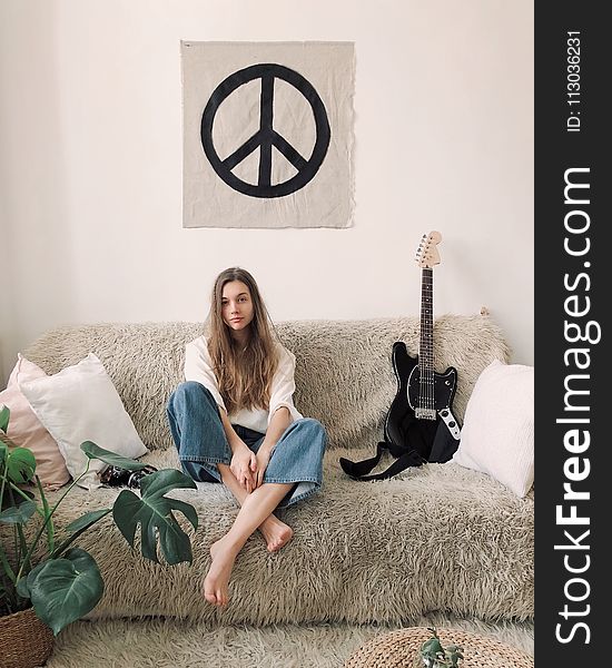 Woman Sitting in Grey Fur Sofa