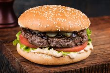 Burger On A Wooden Board Stock Images