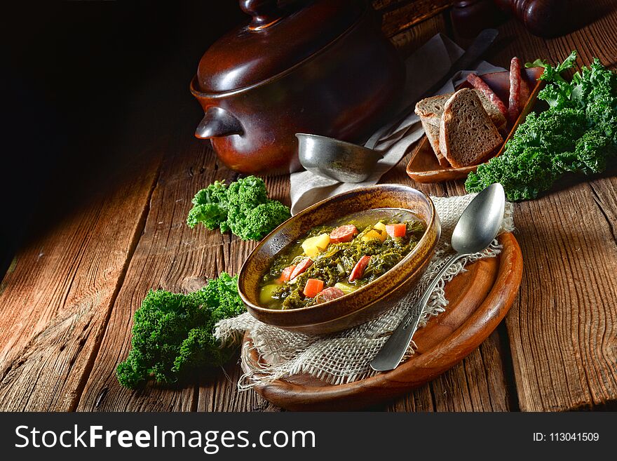 Rustic kale soup with meat and sausage