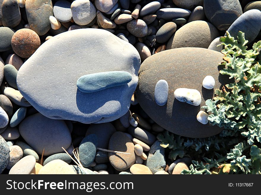 A stone man made of stones on the beach. A stone man made of stones on the beach.