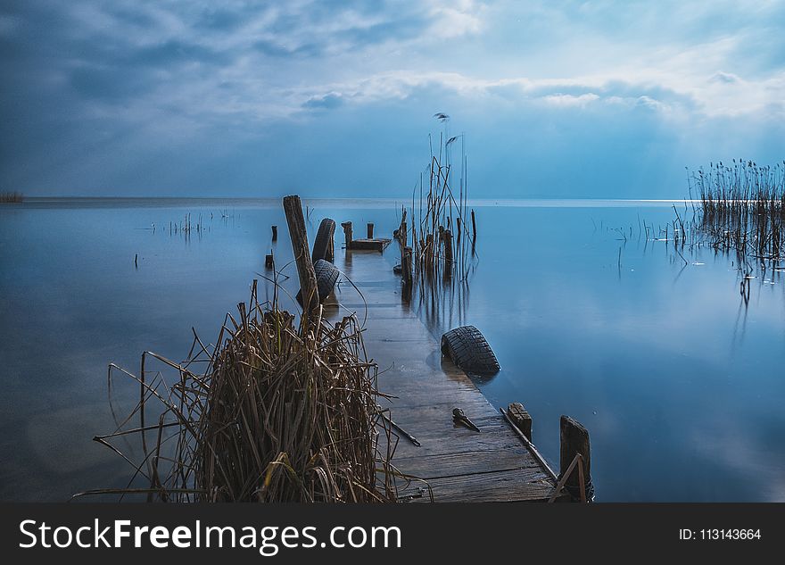 Brown Wooden Dock during Sunset