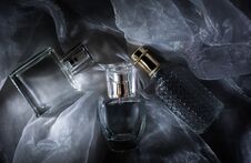 Three Perfume Bottle On Gray Background Royalty Free Stock Photos