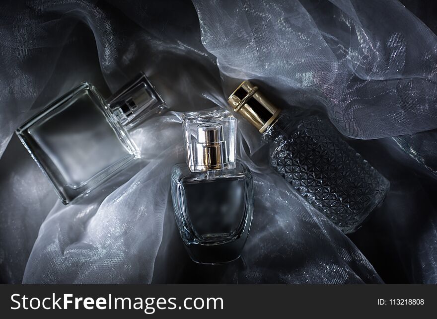 Three Perfume Bottle On Gray Background