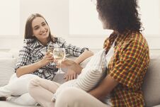Friends Chatting With Wineglasses At Home Stock Photo