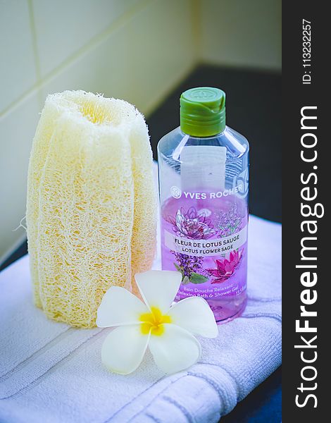 Shallow Focus Photography of Yves Rocher Bubble Bath Bottle on White Towel