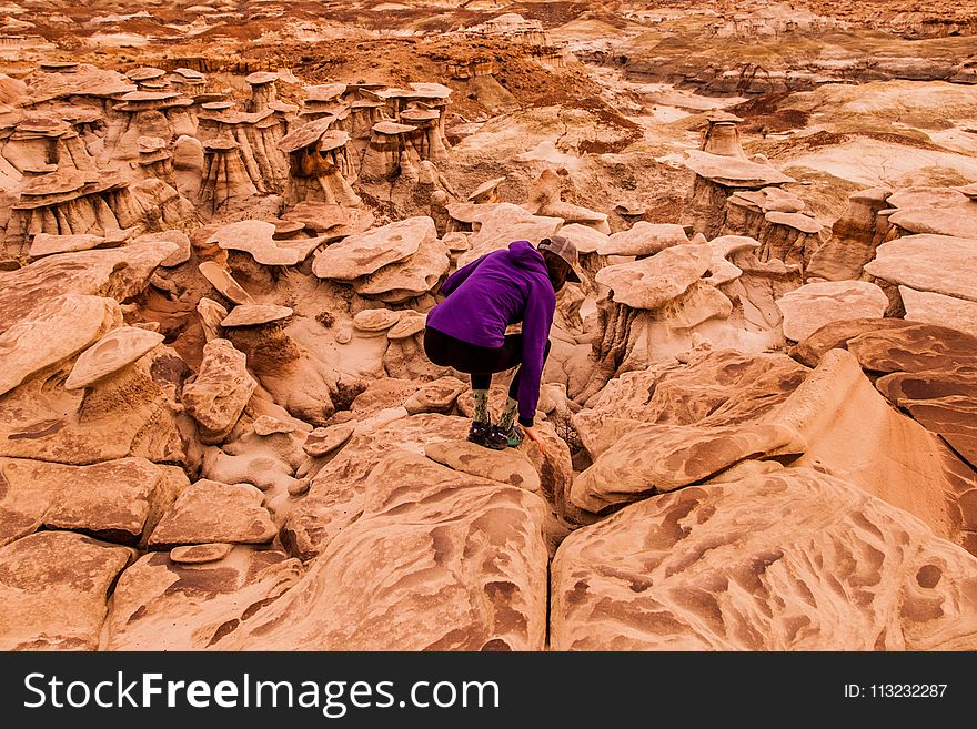 Person Taking Photo of Woman in Purple Sweater