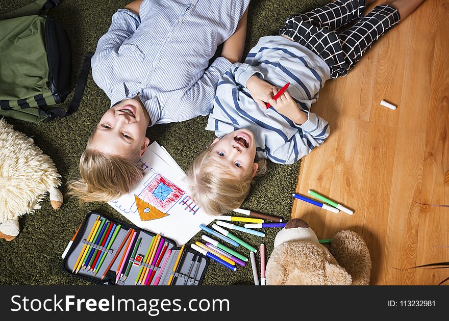 Brothers lying on the floor and draw. Brothers lying on the floor and draw