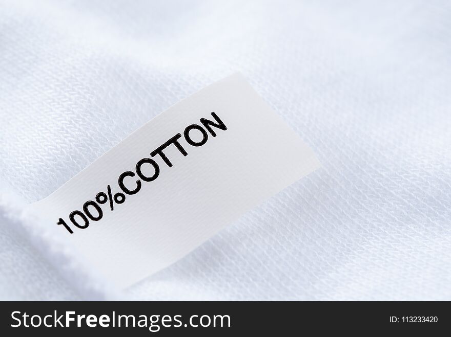 Close up of Cloth tag 100% cotton on white fabric
