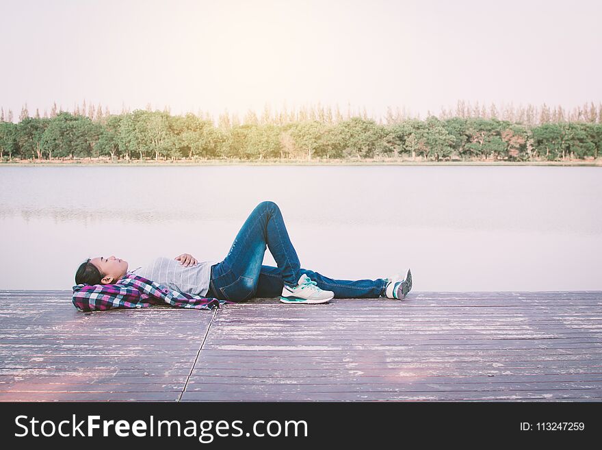 Relaxing moment Asian tourist rest on park ,enjoying time on holiday concept ,color of vintage tone