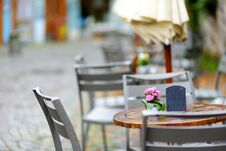Empty Outdoor Cafe On Beautiful Rainy Autumn Day In Lindau, Germany. Empty Chiars And Tables Under Falling Rain In Autumn. Stock Photos