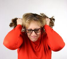 Frustrated Business Woman Pulling Her Hair Out Royalty Free Stock Photography