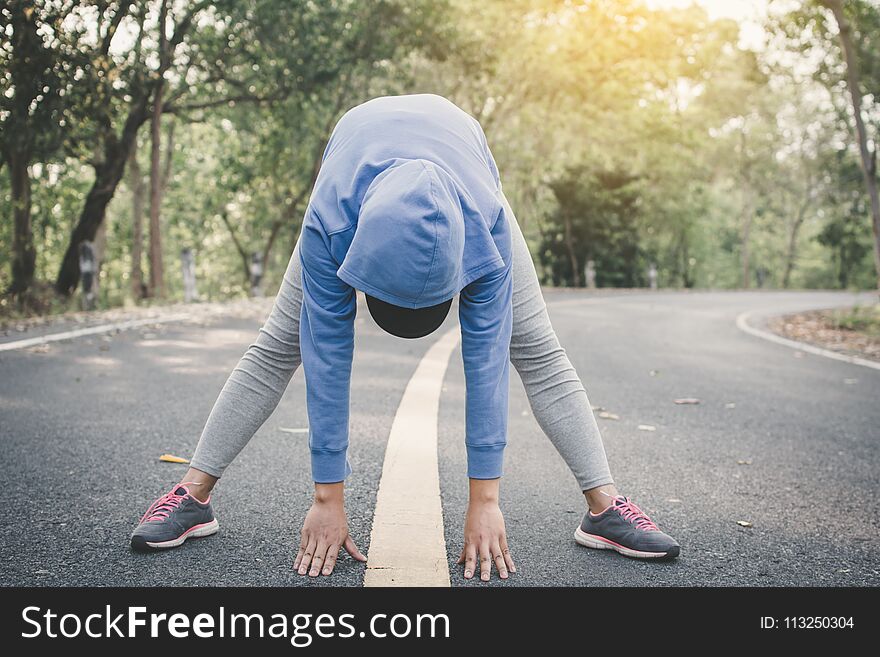 Woman warm up before running on the road for health concept, color of hipster tone selective and soft focus