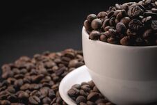 Coffee Incup And Coffee Beans Are The Background. Stock Photography Coffee Incup And Coffee Beans Are The Background. Stock Photography