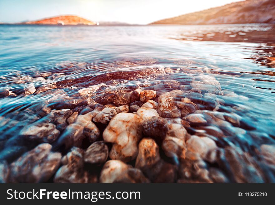 Beauty of underwater nature, the stony bottom is seen through the clear water of the Mediterranean Sea, summer holidays in Greece