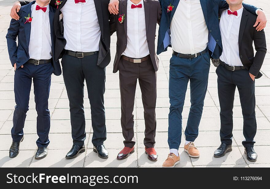 Groom and his friends pose in a restaurant