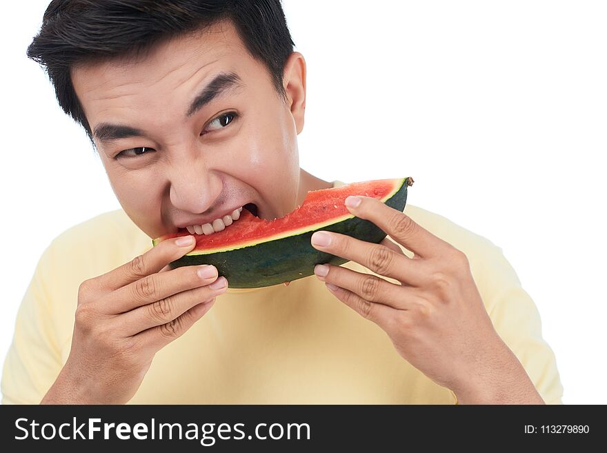 Hungry Vietnamese young man eating sweet watermelon. Hungry Vietnamese young man eating sweet watermelon