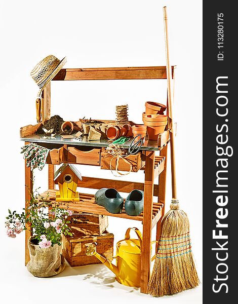 Wooden shelves with gardening tools against white background. Wooden shelves with gardening tools against white background