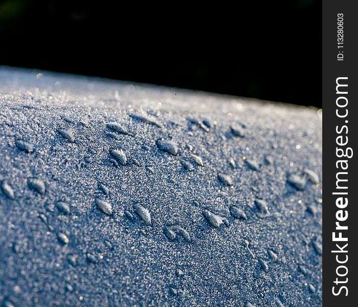 Frozen water droplets forming on car bodywork.