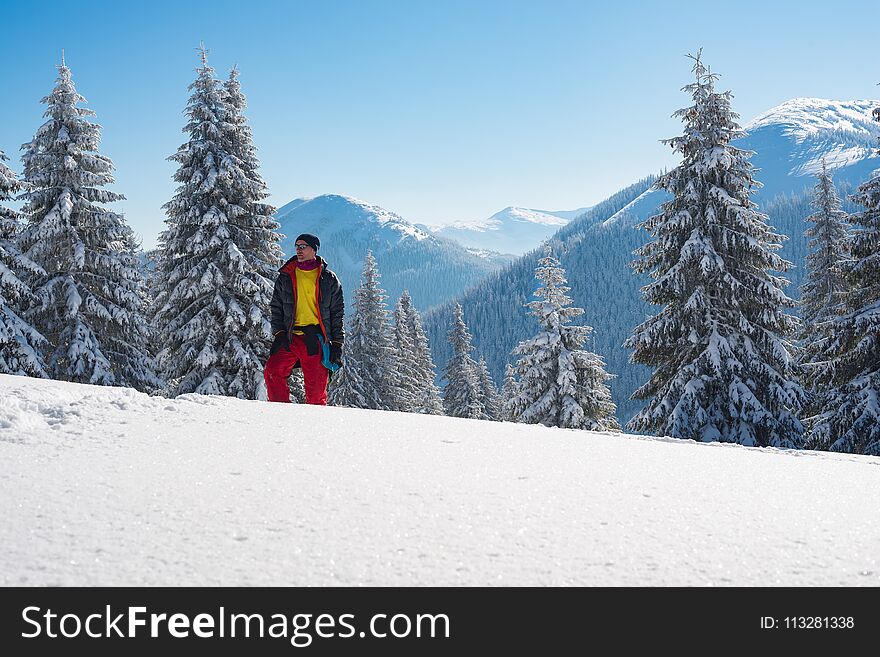 Dreaming Adventurer Is Standing In The Winter Mountains