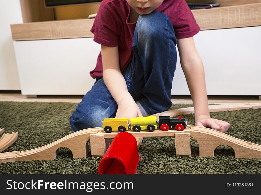 Child Boy Play With Wooden Train, Build Toy Railroad At Home Or