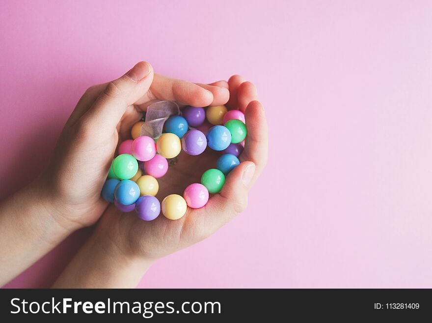 Gently spring multi-colored beads in children`s hands