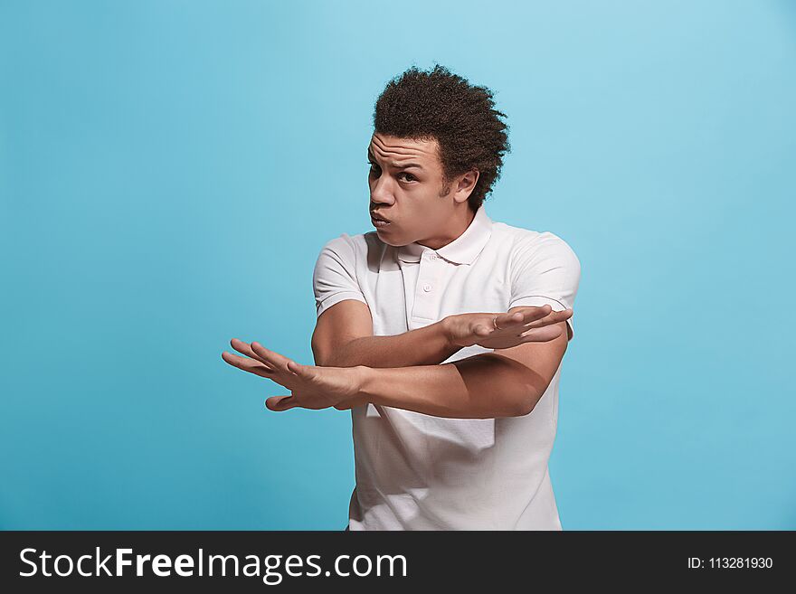 Beautiful Male Half-length Portrait Isolated On Blue Studio Backgroud. The Young Emotional Afro Man