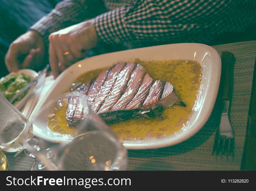 Plate with grilled tuna on table in restaurant