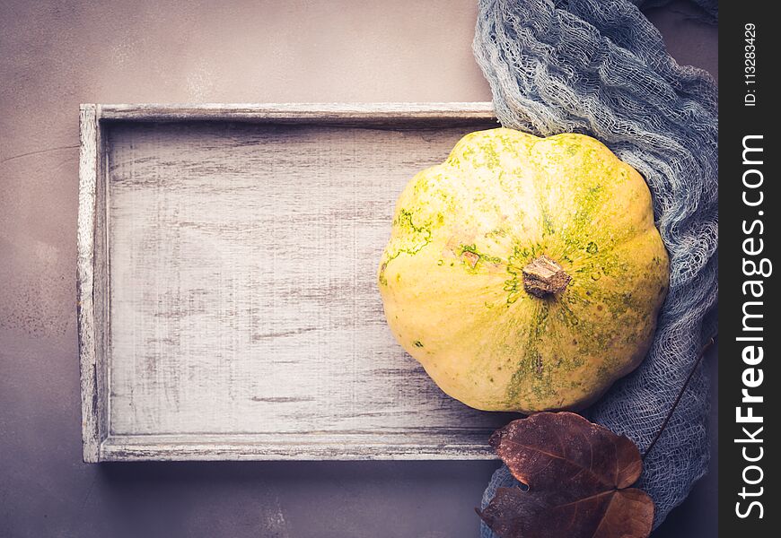 Autumn fall flat lay background with decorative pumpkin on wooden tray. Autumn fall flat lay background with decorative pumpkin on wooden tray