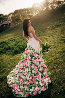 Young Bride In A Dress From Flowers Walking On Grass And Smiling Stock Image