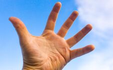 Male Hand Against A Blue Sky With Clouds Stock Images Male Hand Against A Blue Sky With Clouds Stock Images