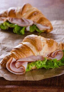 Fresh Croissant With Ham And Salad Stock Photos