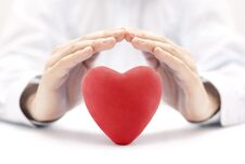 Red Heart Covered By Hands Stock Photo