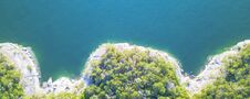 Aerial Trees And Cliff Rock Wall Crystal Water At Lake Travis, A Royalty Free Stock Photo