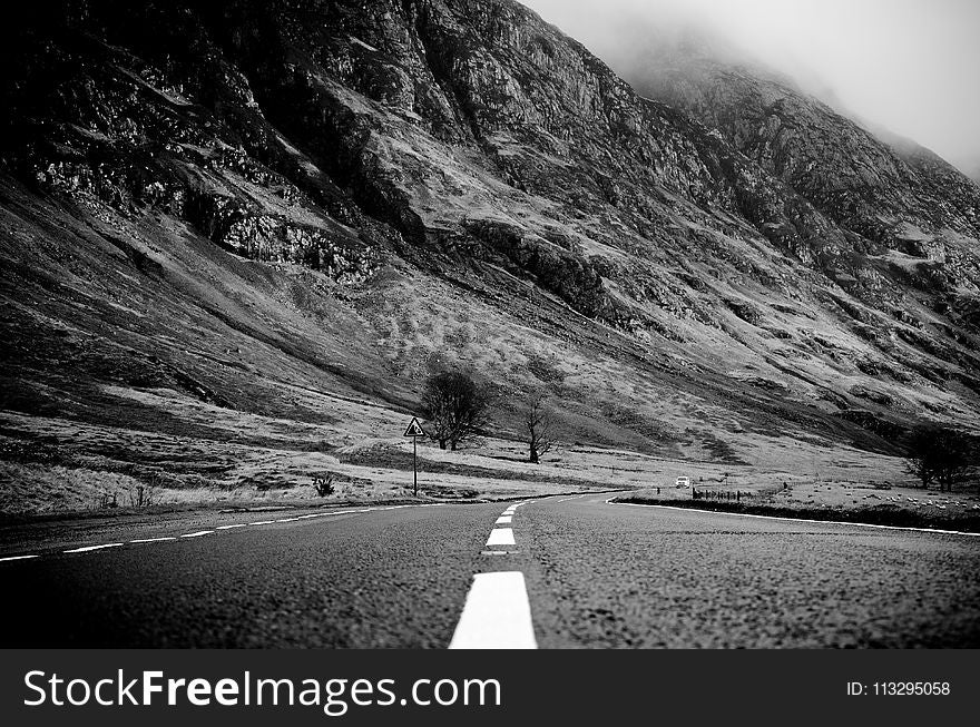 Grayscale Photo Of Road Thru Mountain