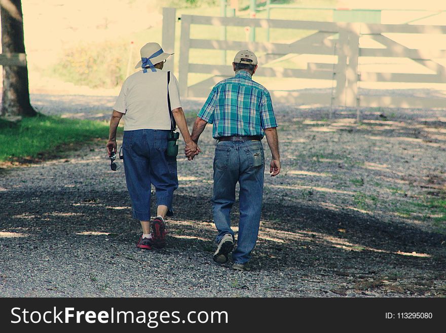 Old Couple Walking While Holding Hands