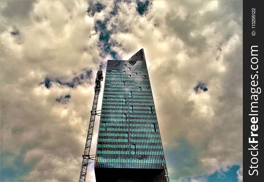 Black High-rise Building With White Clouds