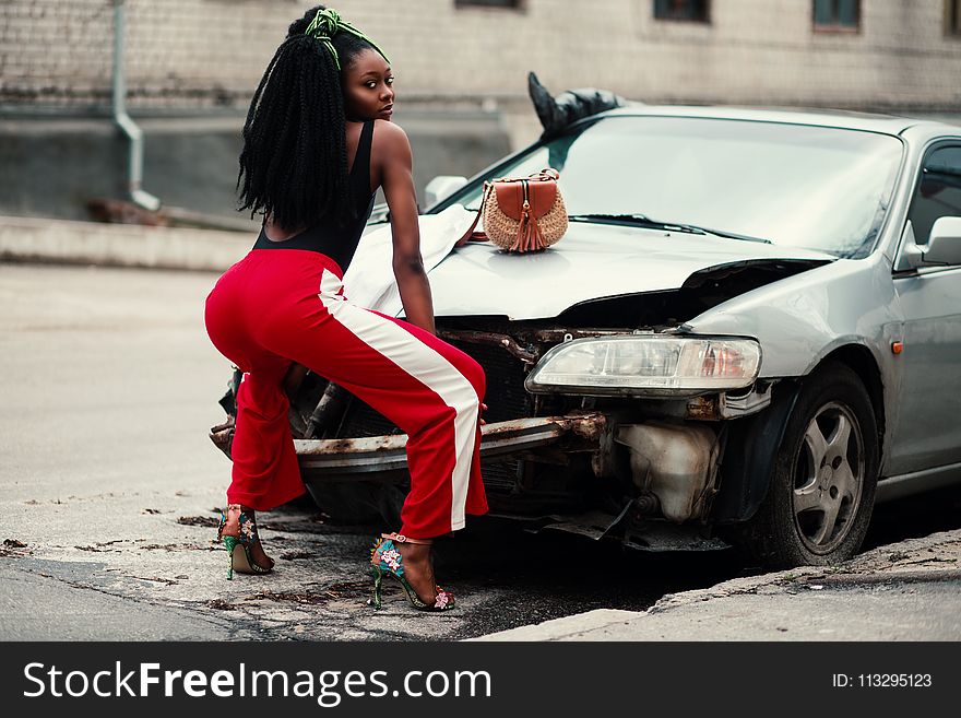 Photograph of Woman About to Twerk in Front of Vehicle
