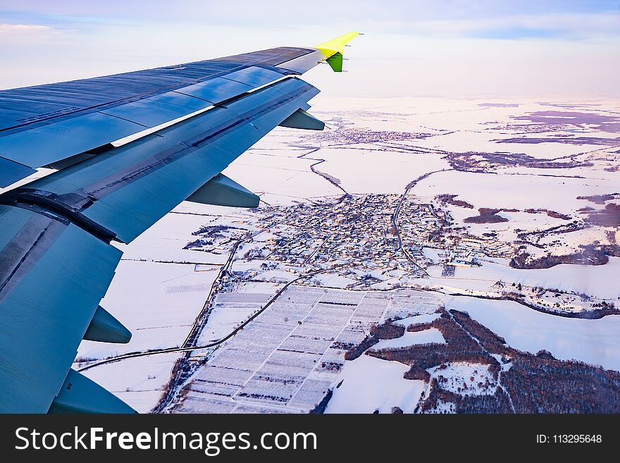 Beautiful scenery from the porthole of a passenger aircraft wing with an engine. Beautiful scenery from the porthole of a passenger aircraft wing with an engine