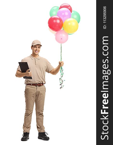 Full length portrait of a delivery man with a clipboard and balloons isolated on white background