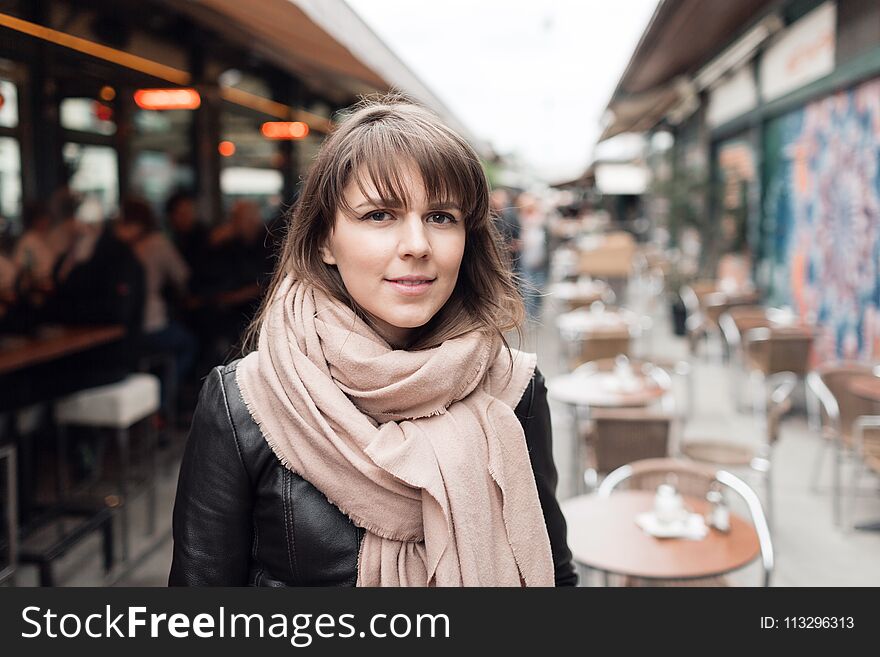 Young tourist girl walks by street. Market in Vienna, Austria.