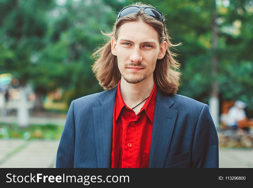 A man with long hair in buisness. A man with long hair in buisness