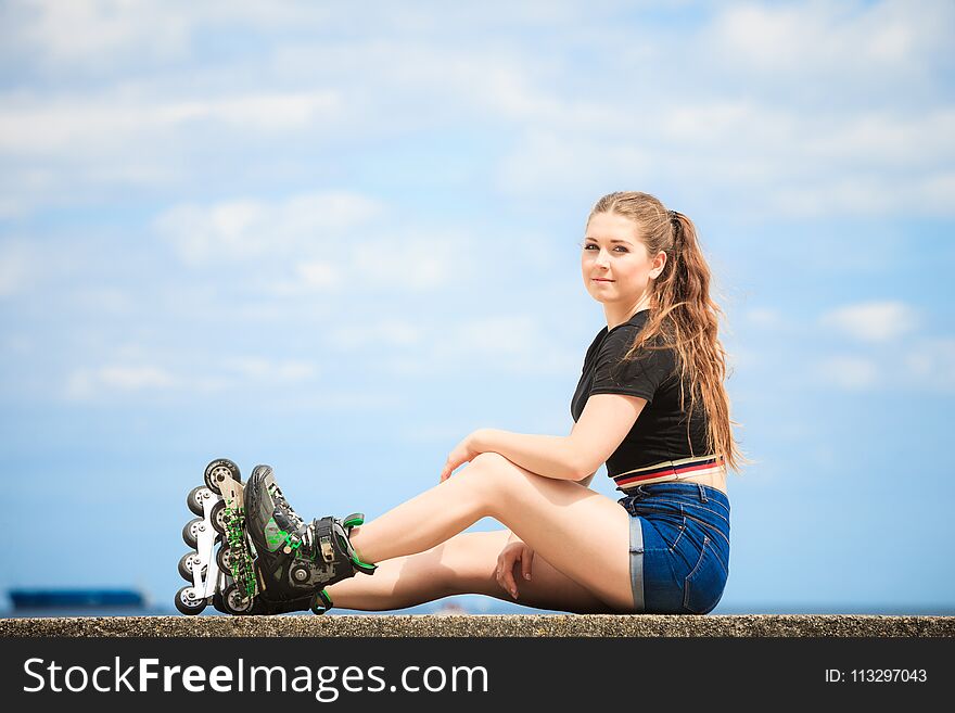 Happy Young Woman Wearing Roller Skates