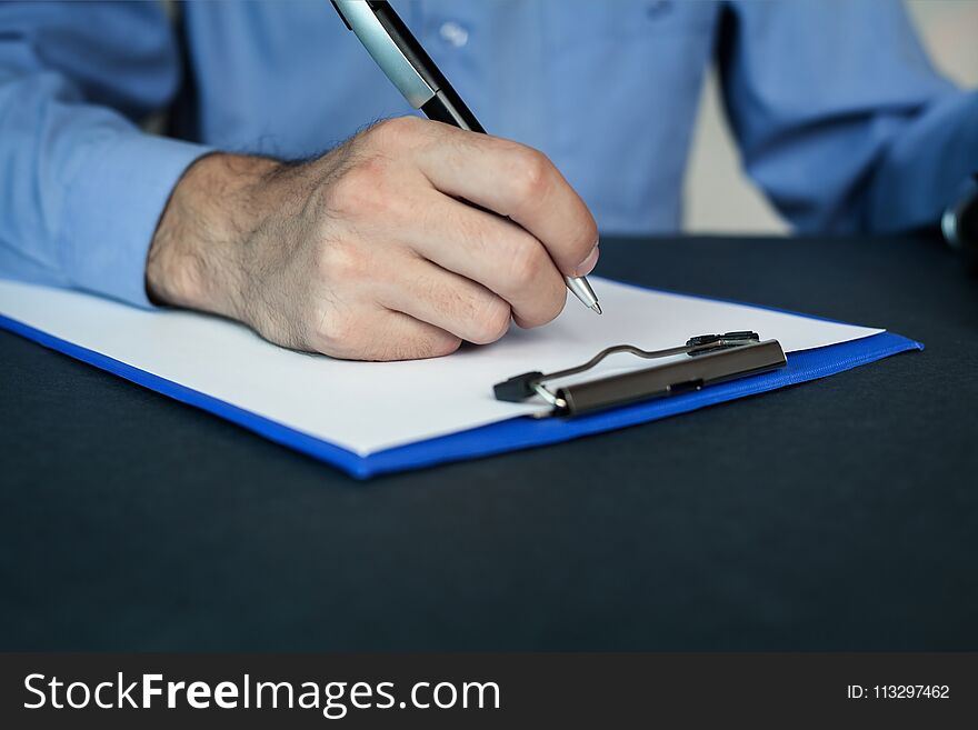 Man writing on a blank paper. Business concept