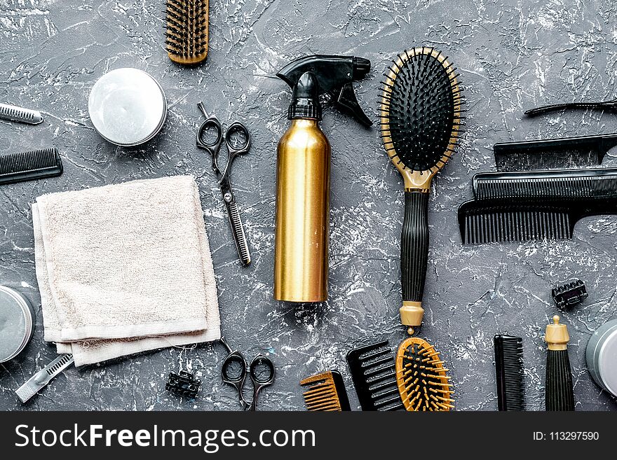 Hair cutting preparation with hairdresser working tools on gray desk background top view. Hair cutting preparation with hairdresser working tools on gray desk background top view