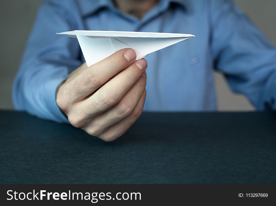 Businessman holding paper airplane. Travel insurance