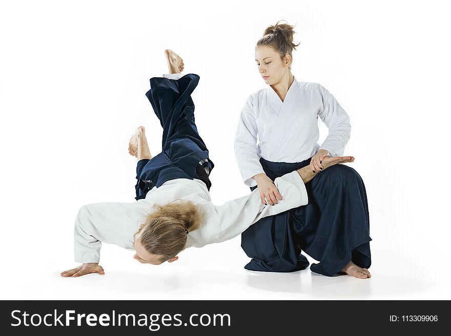 Man and women fighting at Aikido training in martial arts school. Healthy lifestyle and sports concept. Man with beard in white kimono on white background. Karate women with concentrated face in uniform. Isolated on white studio background. Man and women fighting at Aikido training in martial arts school. Healthy lifestyle and sports concept. Man with beard in white kimono on white background. Karate women with concentrated face in uniform. Isolated on white studio background